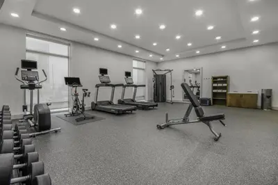 a gym with several treadmills and exercise machines at Home2 Suites By Hilton Cincinnati Midtown Oakley in Cincinnati