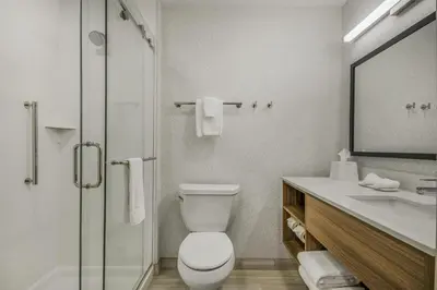 a bathroom with a toilet and a shower and a sink at Home2 Suites By Hilton Cincinnati Midtown Oakley in Cincinnati
