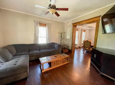 a living room with a couch and a ceiling fan at 4BR-Beautiful Historic Home in Millersburg