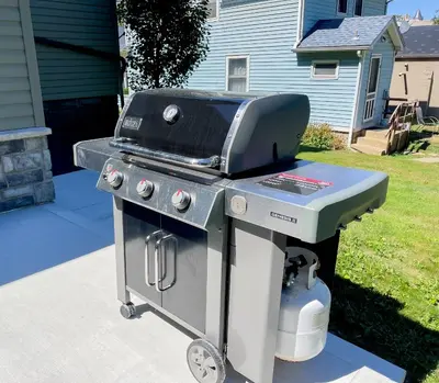 a grill sitting on a driveway next to a house at 4BR-Beautiful Historic Home in Millersburg