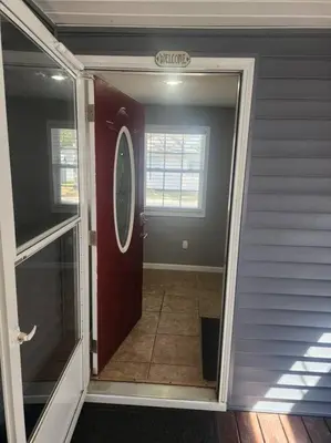 an open door of a house with aoyer with a door at A spacious getaway on Orchard Island in Russells Point