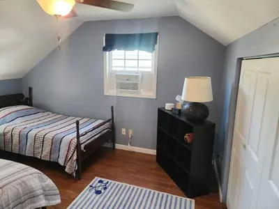a bedroom with a bed and a window at A spacious getaway on Orchard Island in Russells Point