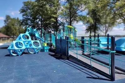 a playground in a park with blue equipment at A spacious getaway on Orchard Island in Russells Point