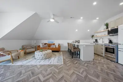 a kitchen and a living room with a table at The Washington Downtown Boutique Hotel in Sandusky