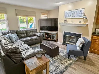 a living room with a couch and a fireplace at On Island Time at Kelleys Island Condo! in Kelleys Island