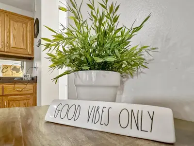 a kitchen counter with a sign that says good vibes only at On Island Time at Kelleys Island Condo! in Kelleys Island