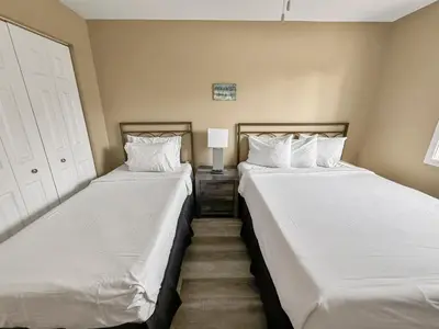 two beds sitting next to each other in a bedroom at On Island Time at Kelleys Island Condo! in Kelleys Island
