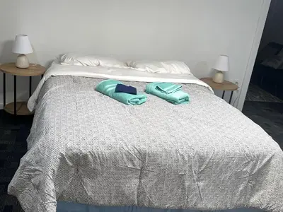 a bed with two towels on top of it at The Cozy Corner in Toledo