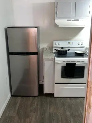 a kitchen with a stainless steel refrigerator and a stove at The Cozy Corner in Toledo