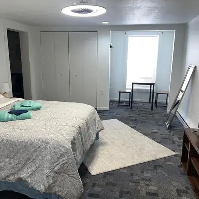 a bedroom with a bed and a dresser and a window at The Cozy Corner in Toledo