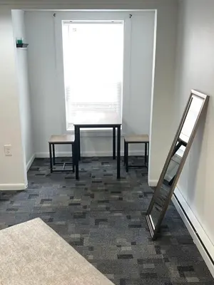 a room with a table and chairs and a mirror at The Cozy Corner in Toledo