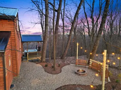 a backyard with a fire pit and a building at Hot tub, fireplace, fire pit, pool table, grill, EV, pets, HOA lake in Amanda