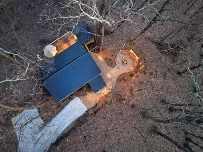 an overhead overhead view of a blue building on the ground at Hot tub, fireplace, fire pit, pool table, grill, EV, pets, HOA lake in Amanda