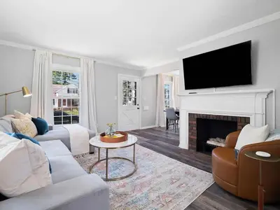a living room with a couch and a fireplace at Home Away From Home - Beautiful Yard in South Euclid