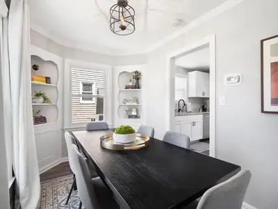 a dining room with a black table and chairs at Home Away From Home - Beautiful Yard in South Euclid