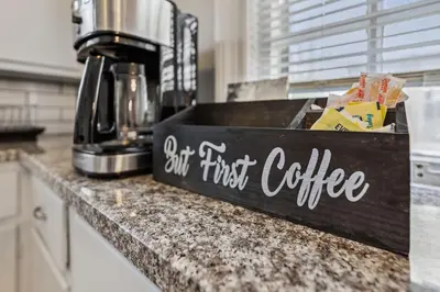 a wooden first coffee sign on a kitchen counter at Near CLE Clinic - Long term stays accepted in Shaker Heights