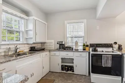 a kitchen with white cabinets and a stove top oven at Near CLE Clinic - Long term stays accepted in Shaker Heights