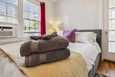 a pile of towels sitting on top of a bed at Near CLE Clinic - Long term stays accepted in Shaker Heights