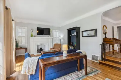 a living room with a blue couch and a fireplace at Near CLE Clinic - Long term stays accepted in Shaker Heights