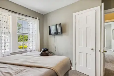 a bedroom with a bed and a tv on the wall at Near CLE Clinic UH & Case Western in Shaker Heights