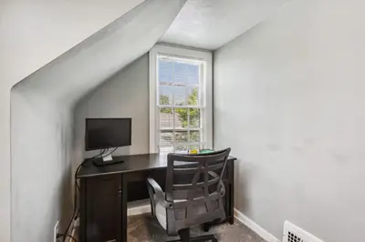a desk with a computer and a chair in a room at Near CLE Clinic UH & Case Western in Shaker Heights