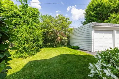 a yard with a white garage and green grass at Near CLE Clinic UH & Case Western in Shaker Heights