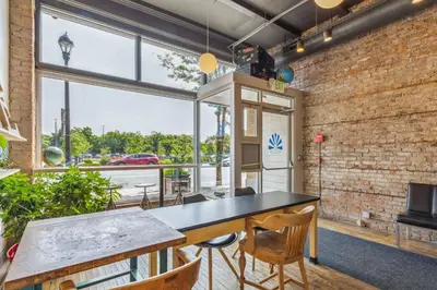 a room with a table and chairs and a large window at The Victor 2 - Cleveland's Urban Lodge in Cleveland