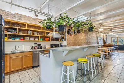 a kitchen with a counter and some stools at The Victor 2 - Cleveland's Urban Lodge in Cleveland