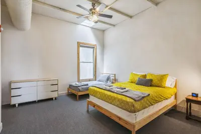 a bedroom with a bed and a dresser and a mirror at The Victor 3 - Cleveland's Urban Lodge in Cleveland