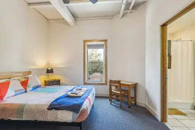 a bedroom with a bed and a desk and a window at The Victor 3 - Cleveland's Urban Lodge in Cleveland