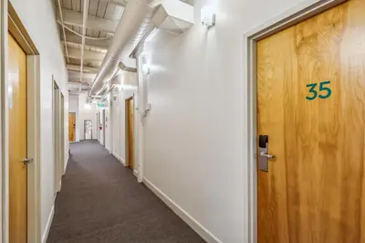 a hallway in an office building with a number on the door at The Victor 3 - Cleveland's Urban Lodge in Cleveland