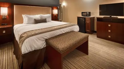 a hotel room with a bed and a television at Best Western Plus Boardman Inn & Suites in Poland