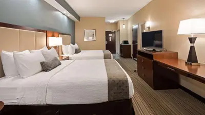 a hotel room with two beds and a flat screen tv at Best Western Plus Boardman Inn & Suites in Poland