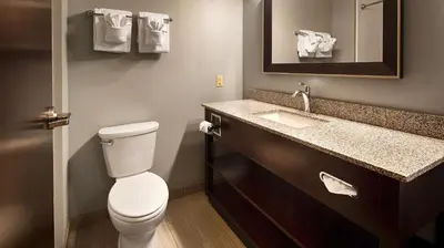 a bathroom with a toilet and a sink at Best Western Plus Boardman Inn & Suites in Poland