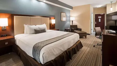 a hotel room with a large bed and a desk at Best Western Plus Boardman Inn & Suites in Poland