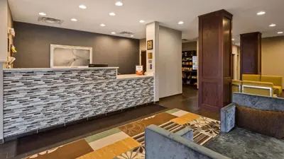 a lobby of a store with a counter and chairs at Best Western Plus Boardman Inn & Suites in Poland