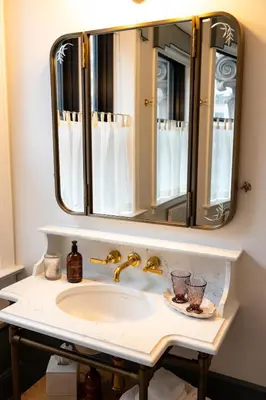 a bathroom sink with a large mirror above it at Fidelity Hotel in Cleveland
