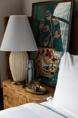 a lamp on a night stand next to a bed at Fidelity Hotel in Cleveland