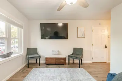 two chairs and a table in a living room with a ceiling fan at Private Ranch - Entire Home - 3 Bed Room - Hot Tub - King Bed - Fenced Yard - Pets & Kids Welcome - Game Shed - Free WiFi in Columbus