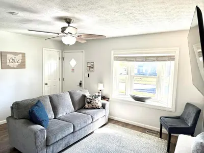 a living room with a couch and a ceiling fan at Private Ranch - Entire Home - 3 Bed Room - Hot Tub - King Bed - Fenced Yard - Pets & Kids Welcome - Game Shed - Free WiFi in Columbus