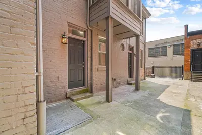 an empty alleyway between two brick buildings with a door at The Beer Baron House - Rhinegeist - FREE Streetcar in Cincinnati