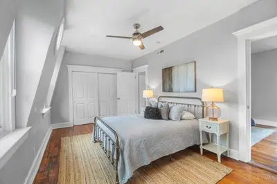 a bedroom with a bed and a ceiling fan at The Beer Baron House - Rhinegeist - FREE Streetcar in Cincinnati