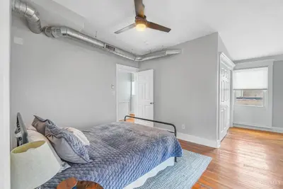 a bedroom with a bed and a ceiling fan at The Beer Baron House - Rhinegeist - FREE Streetcar in Cincinnati