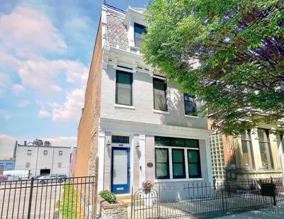 a white house with a fence in front of it at The Beer Baron House - Rhinegeist - FREE Streetcar in Cincinnati