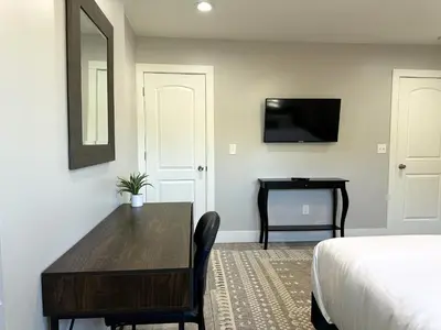a bedroom with a table and a bed and a desk at Charming 2BR Near Downtown & Attractions in Columbus