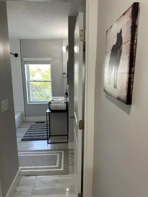 a hallway with a cat painting on the wall at Charming 2BR Near Downtown & Attractions in Columbus