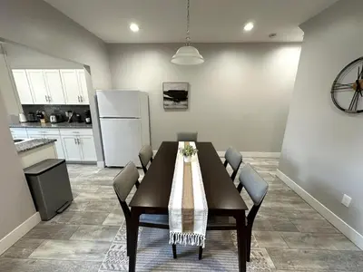 a dining room table with chairs and a kitchen at Charming 2BR Near Downtown & Attractions in Columbus