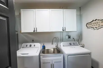a small kitchen with a sink and white appliances at Rocky river Escape in Cleveland