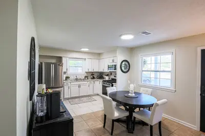 a kitchen and dining room with a table and chairs at Rocky river Escape in Cleveland