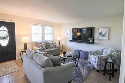 a living room with couches and a flat screen tv at Rocky river Escape in Cleveland